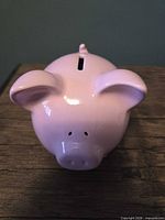 Front view showing coin slot and glossy pink finish