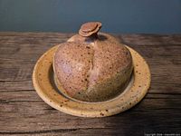 Top view of speckled ceramic butter keeper on base