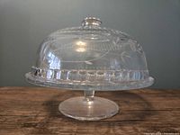Cake stand with dome assembled, side view showing etching and pedestal