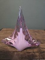 Front view showing pink and white swirl glass tealight holder with pointed finial