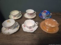 Front view showing all six teacup and saucer sets