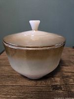 Side view of brown ombre covered casserole showing body and lid