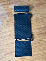 full view of mat, pillow and foot pad laid out on floor