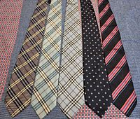 Front view of all five Burberry ties laid side by side