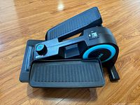 Overall view of Cubii elliptical showing both foot pedals and teal accent