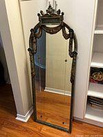 Front view of full mirror showing carved frame, swag details, overall size