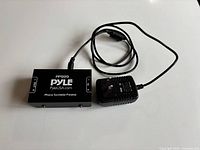 Top view of Pyle PP999 preamp with power adapter