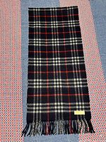 Full view of Burberrys navy red cream check cashmere scarf showing pattern and fringes
