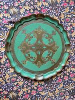 Top view showing green and gold scroll design on round tray