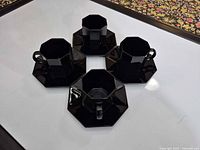 Top view showing four octagonal cups each on an octagonal saucer