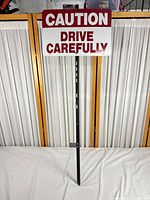 Full view of sign mounted on stake showing proportions