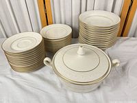 all pieces stacked: saucers, plates, bowls, covered tureen