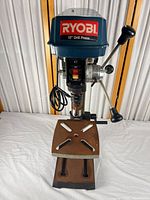 Front view of Ryobi drill press showing head, table and handles