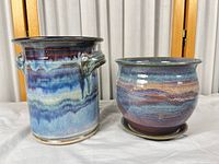 Both iridescent multicolor glazed stoneware pots side by side