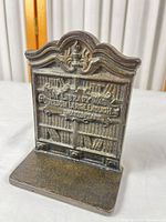 Front view of cast iron bookend with quote and bookshelf design