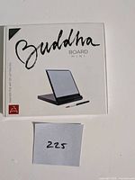 Front of unopened Buddha Board Mini retail box showing product image and brush