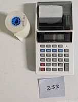 Calculator front view with spare paper roll