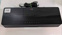 Top view of LG CM3330B unit with power adapter placed on top