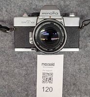 Front view of Minolta SR-T 101 camera with Rokkor 55mm f/1.7 lens and neck strap