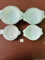 Top-down view of four white Pyrex casserole bowls