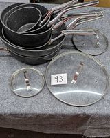 Stacked saucepans and fry pan plus two glass lids
