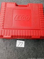 Top view of closed red Lego case showing overall condition and molded logo