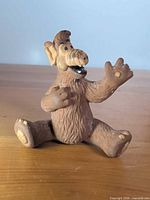 Front view of seated ALF rubber figurine
