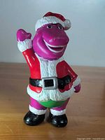 Front view of Barney Santa figurine