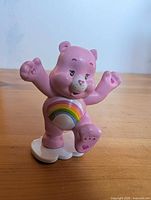 Front view of pink Cheer Bear figure showing rainbow belly and stance