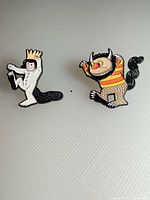 Both enamel pins side by side