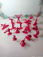 All 17 red plastic sports figures overview