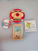 All four pinback buttons displayed on flat surface