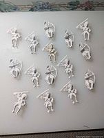 Fifteen unpainted plastic figures laid out for full count view