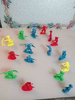 Group of multicolour plastic cowboy and Native American figurines spread on surface