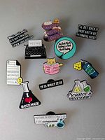 Group shot of all twelve enamel pins