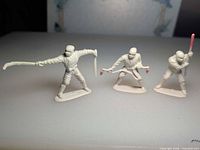 All three white plastic ninja figurines standing