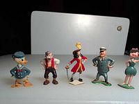 All five figurines lined up front view