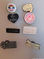 Group shot of all eight enamel pins