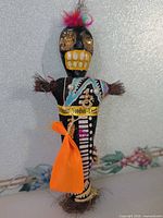 Front view showing face, fabric body, ribbon, charm