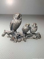 front view showing owl trio, branch, leaves, frog detail