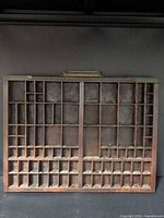 full view of wooden printer’s case showing compartments and handle