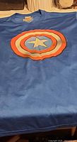 Full view of blue T-shirt with Captain America shield graphic