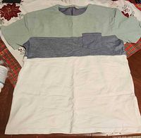 Full view of color-block T-shirt showing three color sections and chest pocket