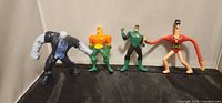 Group shot of all four DC Comics McDonald’s figures standing side by side