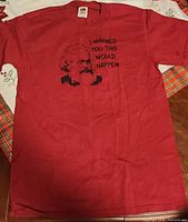 Front view of red Fruit of the Loom T-shirt with Nostradamus graphic and slogan