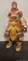 Front view of League of Legends Wukong action figure displaying armor colors and missing arm