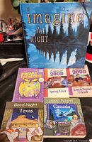 All six books displayed: Imagine a Night standing, five assorted titles laid flat