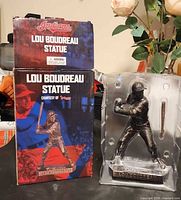 Statue in clamshell next to Cleveland Indians box front