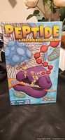 Front of sealed Peptide board game box