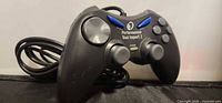 Front angled view of Performance Dual Impact 2 wired controller showing buttons, analog sticks and attached cable